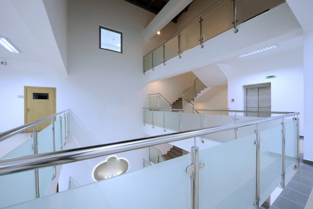 Modern staircase and hall with glass banister